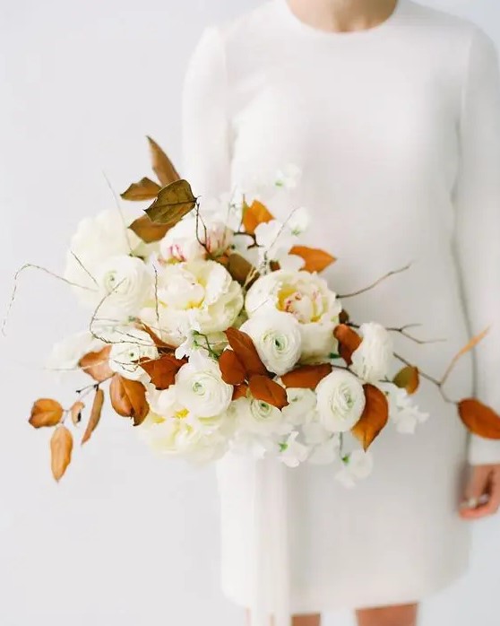 a neutral bridal bouquet with some herbs and rust-colored leaves for a contrast