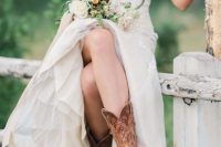 a pretty glam strapless wedding dress with an embellished bodice, a tulle skirt, brown cowgirl boots with patterns for a fall wedding