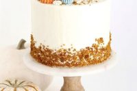 a pumpkin spice wedding cake with cream cheese buttercream, with colorful pumpkin-inspired meringues, with rust crusts