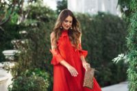 a red pleated midi dress with open shoulders, nude shoes and a printed clutch plus statement earrings