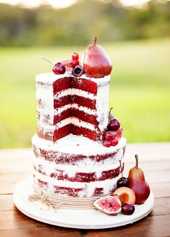 a red velvet naked wedding cake decorated with berries and pears is a lovely wedding dessert solution for a fall soiree