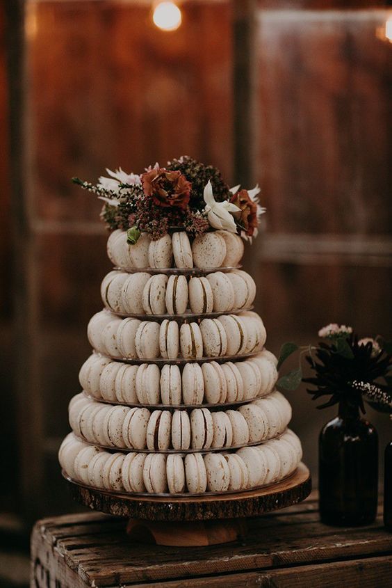 a refined fall wedding macaron tower with some dark decadent blooms is a lovely idea for a fall wedding in any style