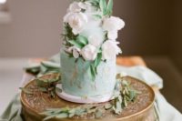 a refined wedding cake with white and textural mint and copper tiers, sugar white blooms and sugar foliage