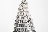 a super modern black and white ombre macaron tower with a marble effect and white blooms is a bold and cool idea
