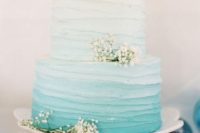 a textural ombre tiffany blue wedidng cake decorated with baby’s breath is a gorgeous idea for a coastal wedding