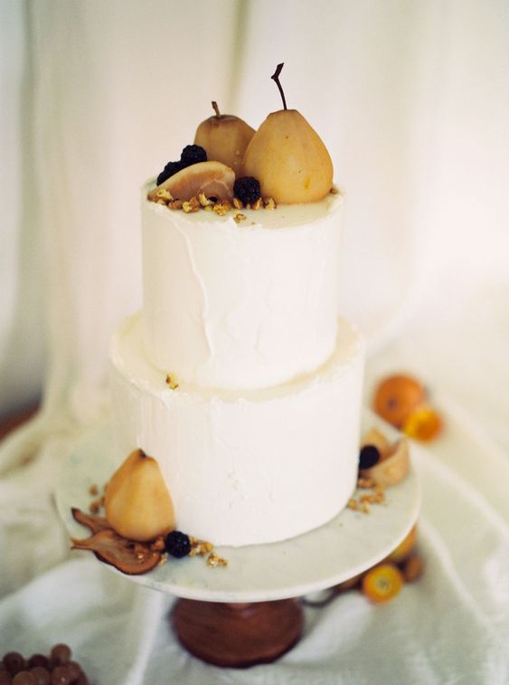 a textural white buttercream wedding cake topped with pears, blackberries and nuts is a lovely idea for a fall wedding