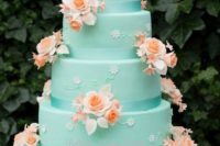 a tiffany blue wedding cake decorated with small and big sugar flowers in coral and white is a bold idea