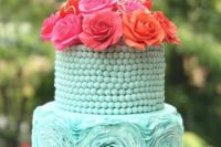 a tiffany blue wedding cake with a bead covered tier and a sugar flower one plus bold fresh blooms on top