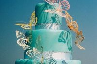 a tiffany blue wedding cake with silver ribbons and colorful rainbow butterflies is a bright and cool idea