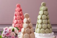 a trio of white, coral pink and green macaron towers is amazing for a bright modern wedding, it’s a chic and bold idea