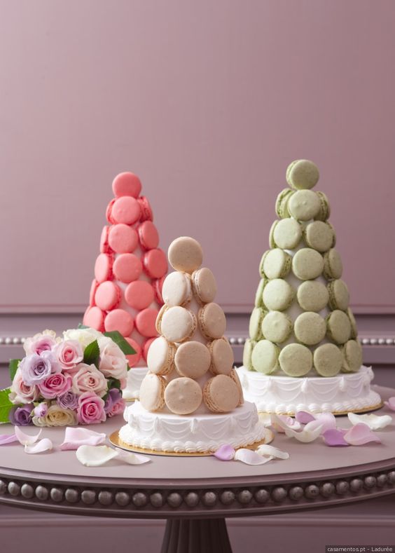 a trio of white, coral pink and green macaron towers is amazing for a bright modern wedding, it's a chic and bold idea