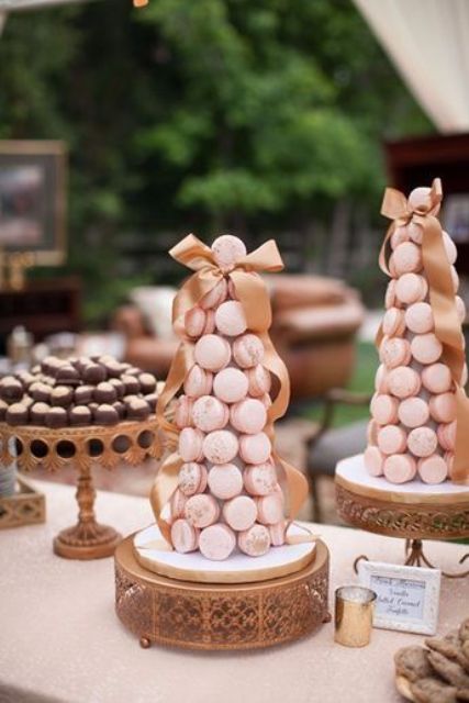 a two mini pink macaron towers with gold bows are amazing for your glam wedding with pink touches