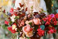 a vibrant oversized fall wedding bouquet with burgundy and green leaves, hot pink blooms and blush touches plus blush ribbons