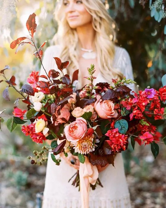 a vibrant oversized fall wedding bouquet with burgundy and green leaves, hot pink blooms and blush touches plus blush ribbons