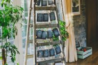 a wedding seating plan of a ladder with a chalkboard seating chart, lights and greenery