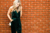 an emerald jumpsuit with a V-neckline, pockets, a metallic bag and nude shoes