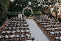 a lovely ceremony space with greenery walls