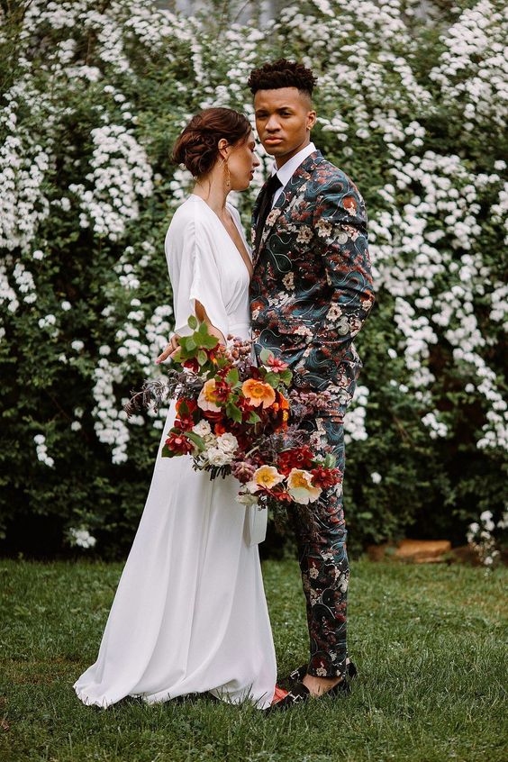 an extra bold printed suit and black loafers, a white shirt and a black tie are a fantastic combo for a boho groom
