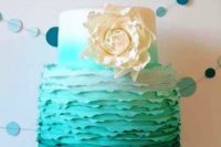 an ombre tiffany blue wedding cake with a textural tier and a large white sugar bloom