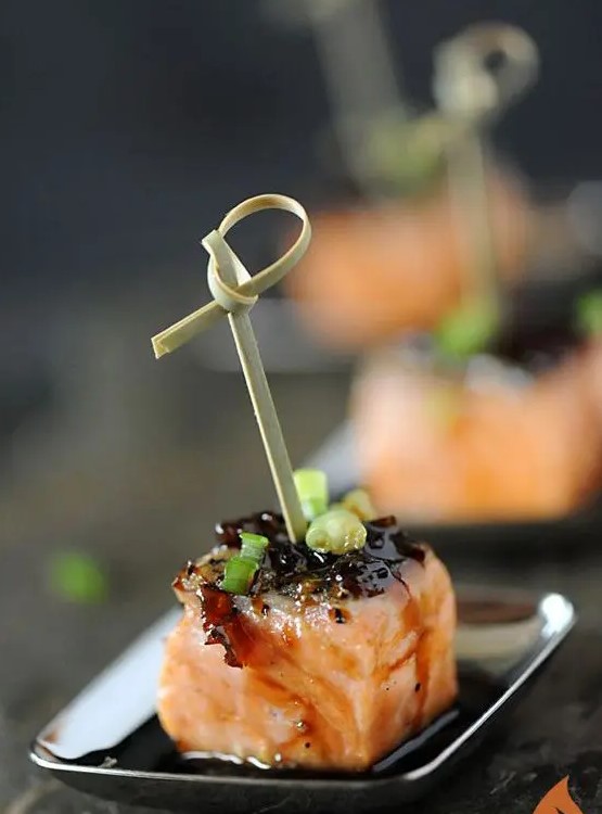 bourbon-glazed salmon appetizer with green onions on skewers is a lovely idea for a fall or winter wedding