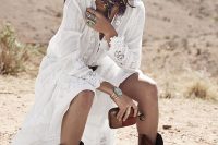 classic cowboy boots – cutout and patterned ones, with a boho lace wedding dress, a tan hat and statement jewelry make this bridal look very boho-like