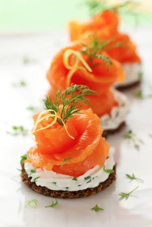 crackers with cream cheese, dill, parsley and smoked salmon for a fresh and tasty snack