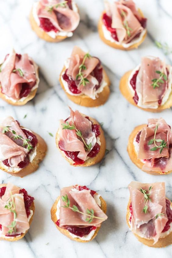 cranberry and proschiutto crostini with touches of herbs are amazing for fall or winter
