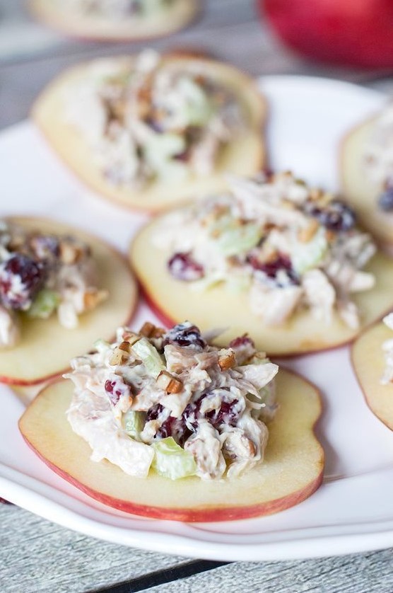 cranberry chicken salad on apple slices is a very unusual and fall-like idea to try