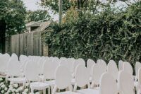 elegant vintage-inspired all-white chairs and white roses along the aisle are great for a modern and sophisticated wedding