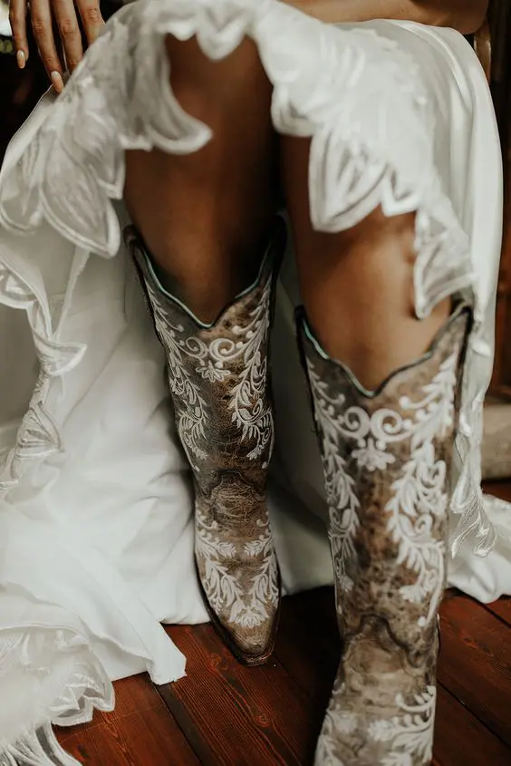 fantastic tan cowgirl boots with white patterns painted are a gorgeous idea for a boho or a rustic bridal look