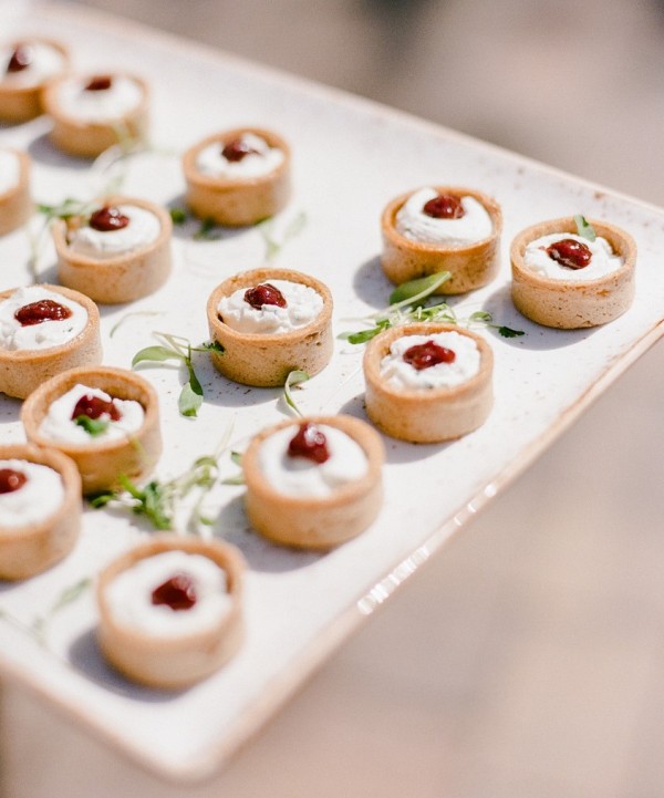 goat cheese tartelettes topped with sun-dried tomatoes and herbs are adorable and delicious cocktail hour wedding appetizers
