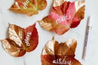 gold-dipped fall leaves with calligraphy as all-natural place cards are amazing for the fall