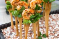 herbed shrimps on forks are simple and delicious wedding cocktail hour appetizers