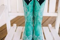 jaw-dropping turquoise cowboy boots with white floral patterns are gorgeous for a boho or rustic bridal look