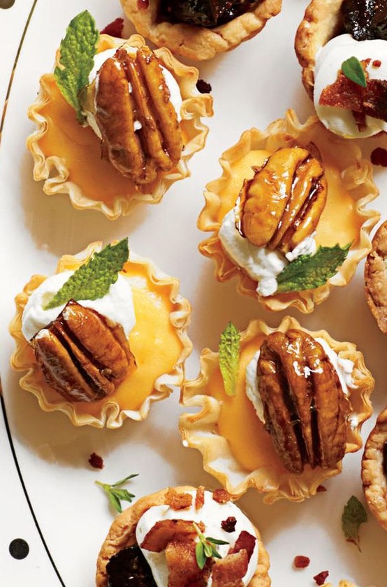 little pastry cups filled with custard, cream cheese, caramelized pecans and some fresh herbs for a winter wedding