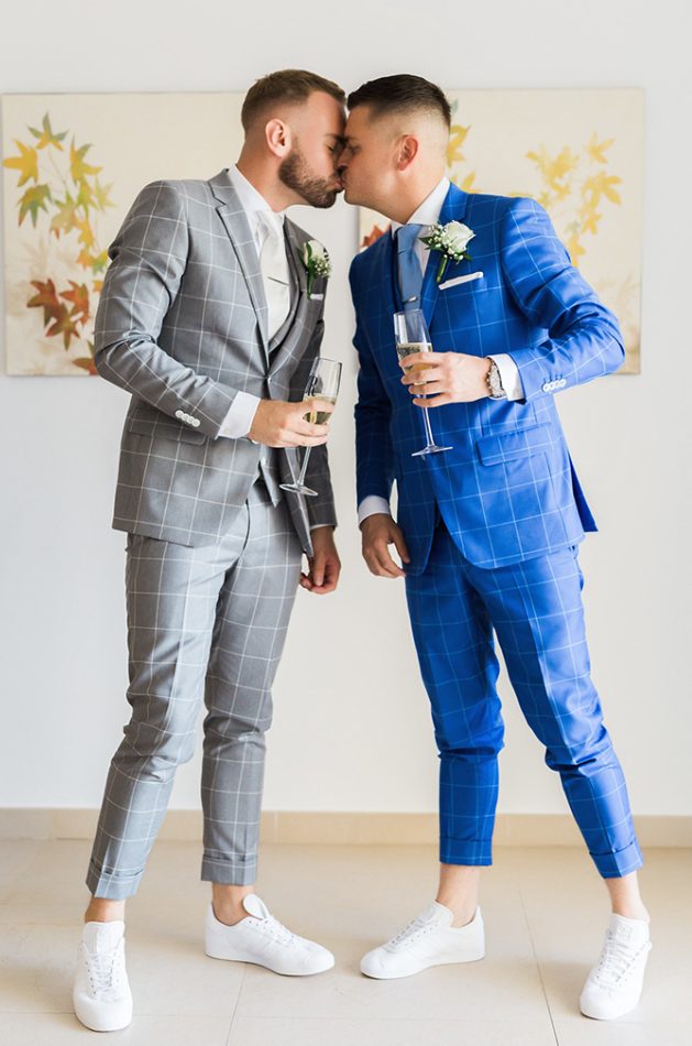 matching three-piece suits with a windowpane print and white sneakers are a bold idea for summer