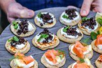 mini pancakes topped with cream cheese, salmon, radish, beluga lentils and herbs are amazing appetizers