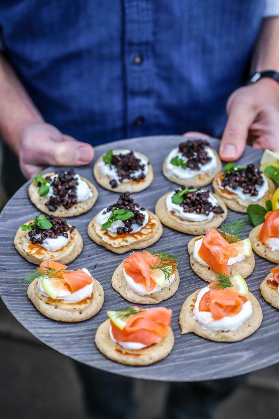 mini pancakes topped with cream cheese, salmon, radish, beluga lentils and herbs are amazing appetizers