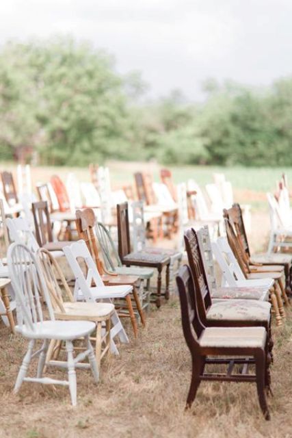 mismatching vintage chairs of various shades of stain and white ones are great for a vintage wedding or a rustic one