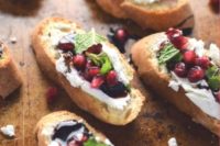 pomegranate and goat cheese crostini with greenery and balsamic are a very refined appetizer idea