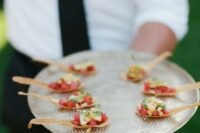 tuna tartare bites with avocado and corn served in wonton spoons are delicious and refined cocktail hour appetizers