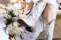 whitewashed leather cowboy boots with carved detailing and cutouts are a hot idea for a rustic wedding or for rocking a touch of boho
