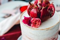 a stylish ombre wedding cake with pomegranates