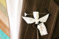 a chic vintage wedding boutonniere wiht a key, a ribbon bow, a tag and an elegant pin is amazing for a wedding