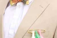 a colorful pin and tassel boutonniere will add color and fun to your look