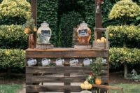 a cozy rustic drink bar of dark stained pallets, with lemons in crates and mason jars