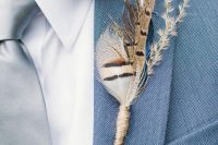 a feather and dried herb wedding boutonniere is a fun and boho touch to rock