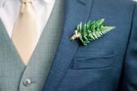 a fern and yarn wedding boutonniere is a fresh and lively wedding accessory