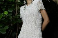 a gorgeous rhinestone fringe mini dress with a high neckline, short sleeves and statement earrings to impress everyone