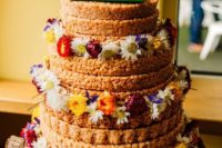a krispie rice wedding cake with colorful blooms and a fun LEGO topper for a whimsy wedding